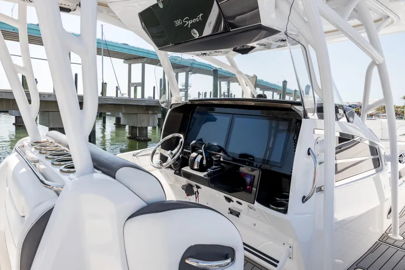 Slide: The Image of 2018 Nor-Tech 390 Sport Center Console boat interior with modern dashboard and steering. - 26