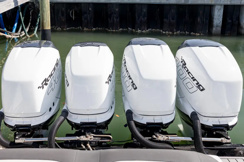 Slide: The Image of Four powerful outboard engines on a 2018 Nor-Tech 390 Sport Center Console boat. - 3