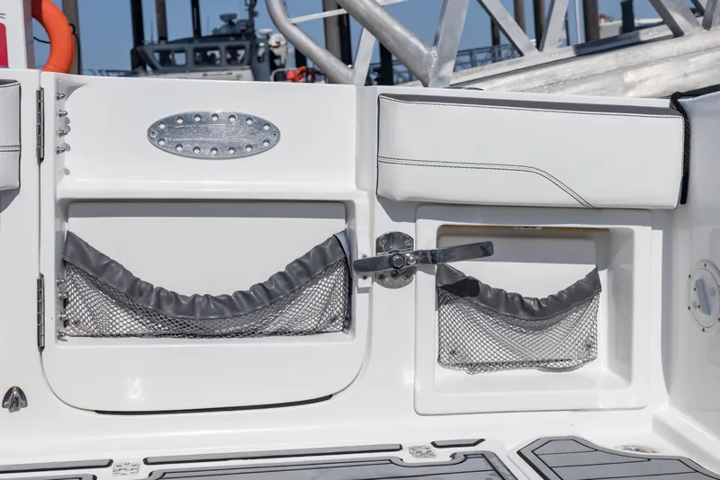 Slide: The Image of 2018 Nor-Tech 390 Sport Center Console boat interior with storage compartments and netting. - 6