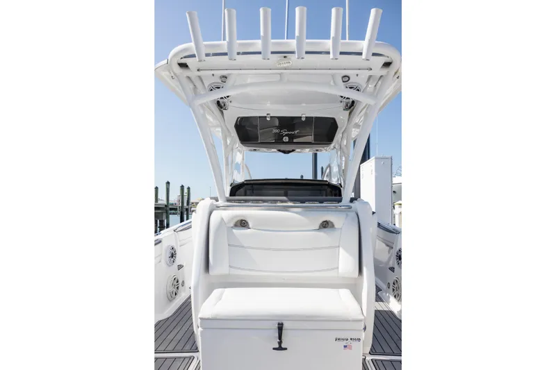 Slide: The Image of 2018 Nor-Tech 390 Sport Center Console boat interior with seating and rod holders. - 7