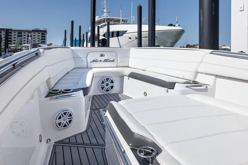 Slide: The Image of 2018 Nor-Tech 390 Sport Center Console boat with sleek white seating and modern design. - 9