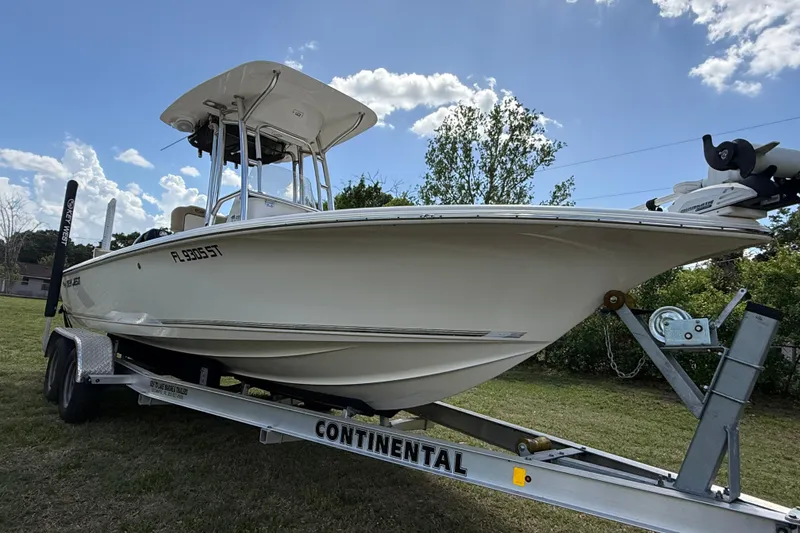 Slide: The Image of 2020 Key West 230 Bay Reef boat on trailer under blue sky. - 13
