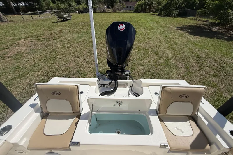 Slide: The Image of 2020 Key West 230 Bay Reef boat with seating and motor, displayed on grass. - 15