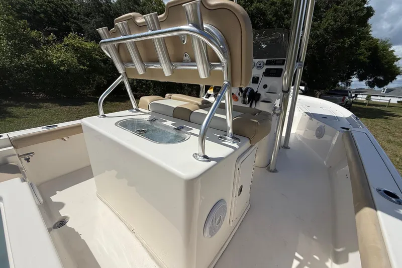 Slide: The Image of 2020 Key West 230 Bay Reef boat interior with seating and console, parked outdoors. - 16