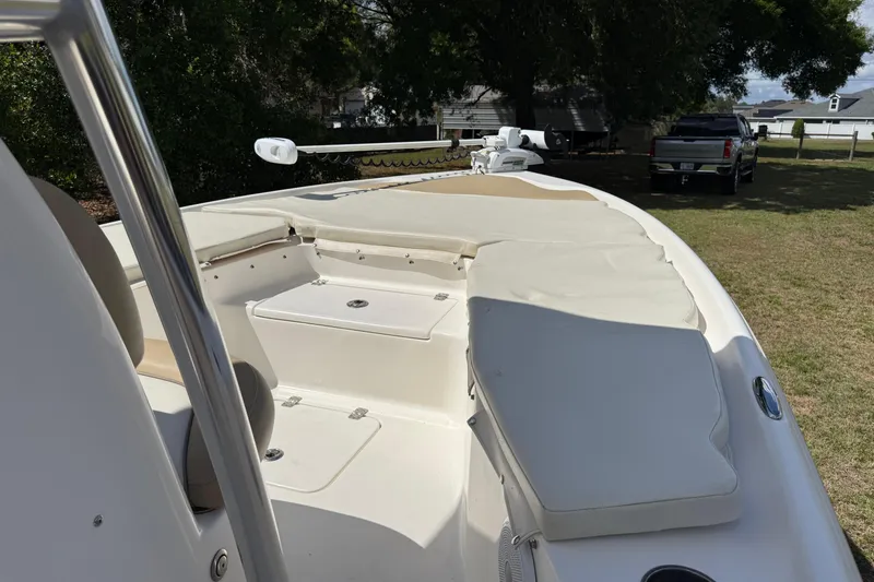 Slide: The Image of 2020 Key West 230 Bay Reef boat with cushioned seating and storage compartments. - 28