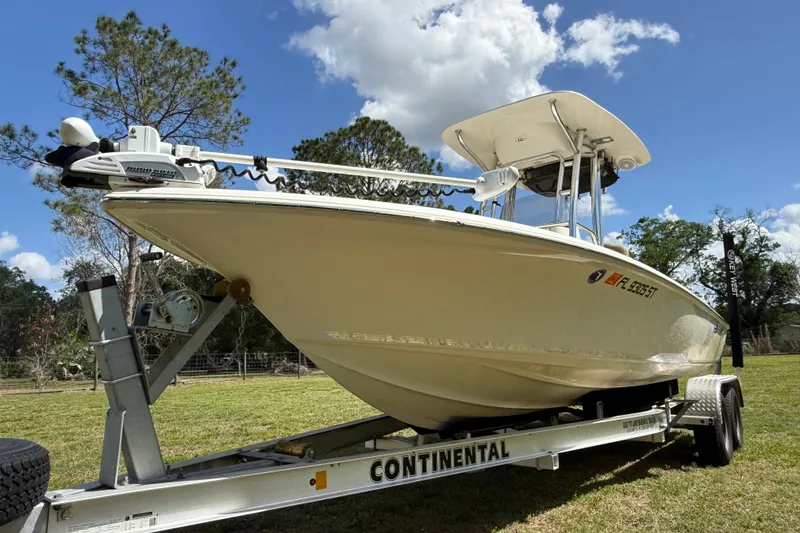 Slide: The Image of 2020 Key West 230 Bay Reef boat on trailer, parked on grass under blue sky. - 7