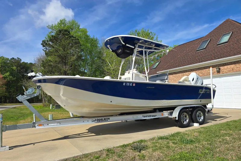 Slide: The Image of 2024 Carolina Skiff 24 Ultra Elite boat on trailer, parked in driveway. - 10