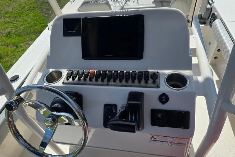 Slide: The Image of 2024 Carolina Skiff 24 Ultra Elite boat console with steering wheel and controls. - 13
