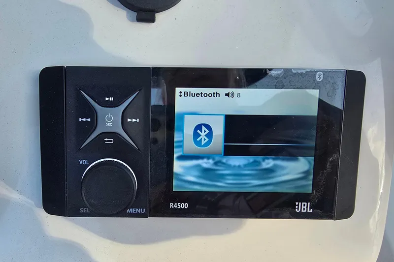 Slide: The Image of Bluetooth audio system on 2024 Carolina Skiff 24 Ultra Elite boat dashboard. - 15