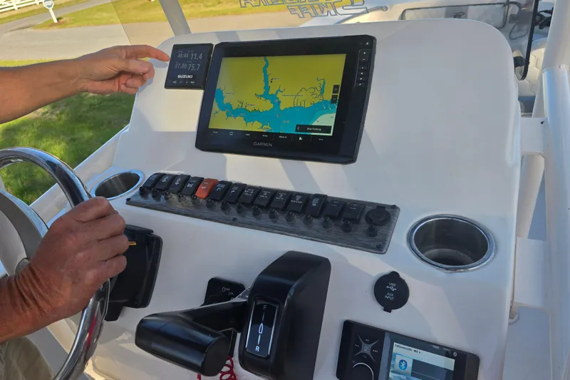 Slide: The Image of 2024 Carolina Skiff 24 Ultra Elite dashboard with Garmin navigation and controls. - 17
