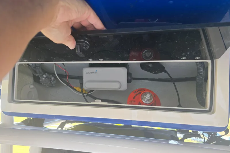 Slide: The Image of 2024 Carolina Skiff 24 Ultra Elite boat electronics compartment with Garmin device. - 18