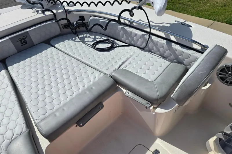 Slide: The Image of 2024 Carolina Skiff 24 Ultra Elite boat interior with cushioned seating and modern design. - 20