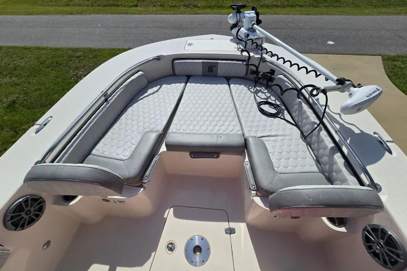 Slide: The Image of 2024 Carolina Skiff 24 Ultra Elite boat interior with cushioned seating and trolling motor. - 22