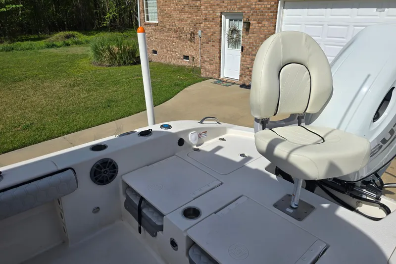 Slide: The Image of 2024 Carolina Skiff 24 Ultra Elite boat interior with seating and storage compartments. - 24
