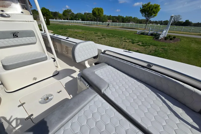 Slide: The Image of 2024 Carolina Skiff 24 Ultra Elite boat interior with gray cushioned seating. - 28