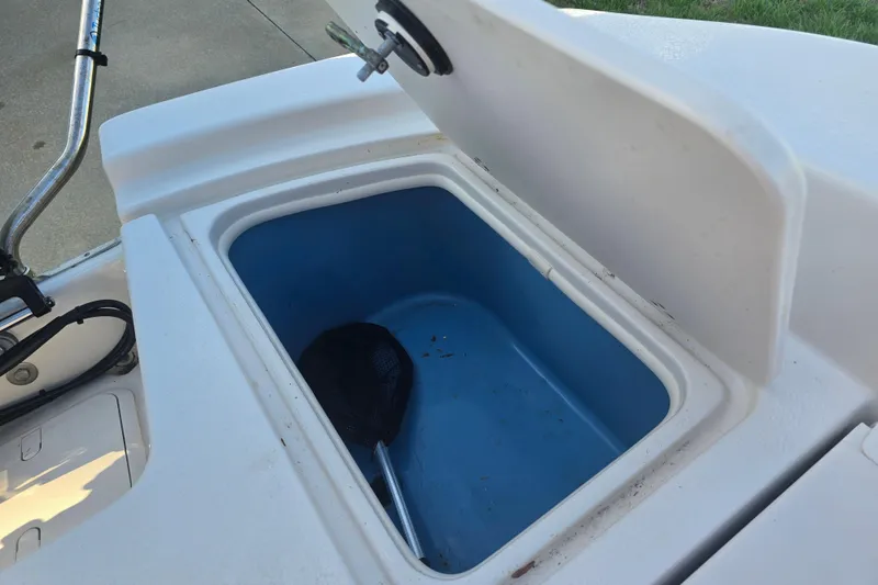 Slide: The Image of Open storage compartment on 2024 Carolina Skiff 24 Ultra Elite boat. - 29