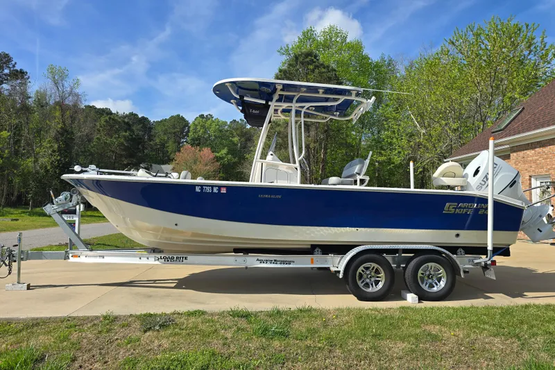 Slide: The Image of 2024 Carolina Skiff 24 Ultra Elite boat on trailer, parked outdoors. - 3