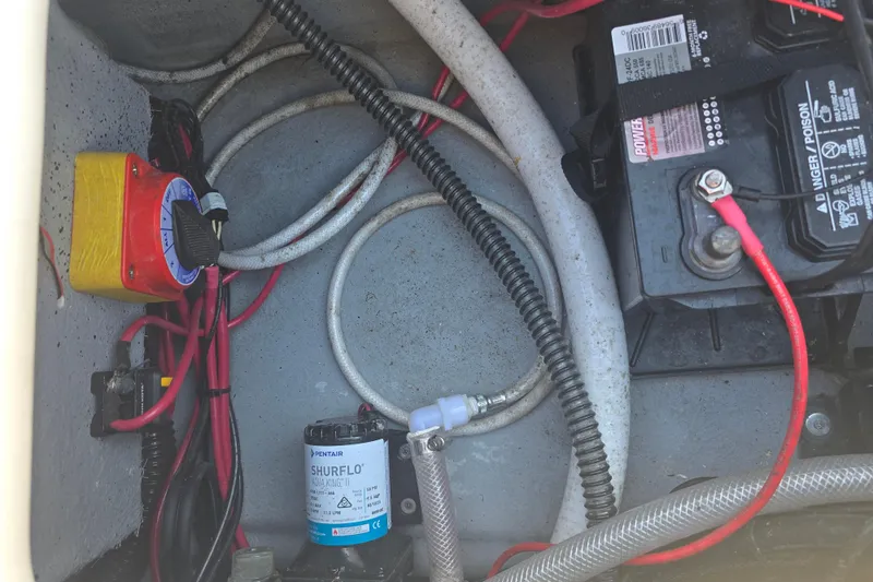 Slide: The Image of 2024 Carolina Skiff 24 Ultra Elite boat wiring and battery compartment. - 31