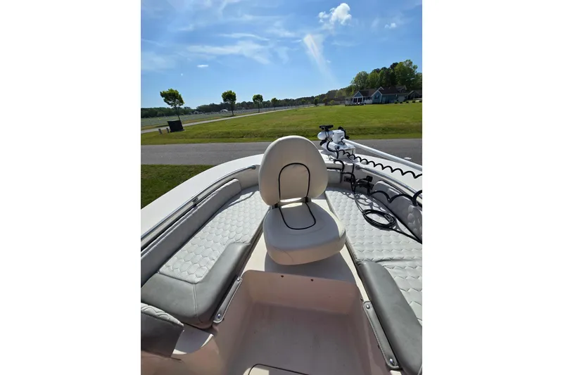 Slide: The Image of 2024 Carolina Skiff 24 Ultra Elite boat interior with seating and clear sky. - 35
