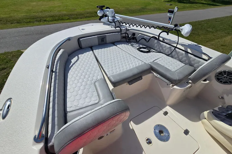 Slide: The Image of 2024 Carolina Skiff 24 Ultra Elite boat interior with cushioned seating and fishing equipment. - 36