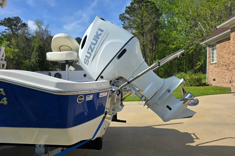 Slide: The Image of 2024 Carolina Skiff 24 Ultra Elite with Suzuki outboard motor in driveway. - 5