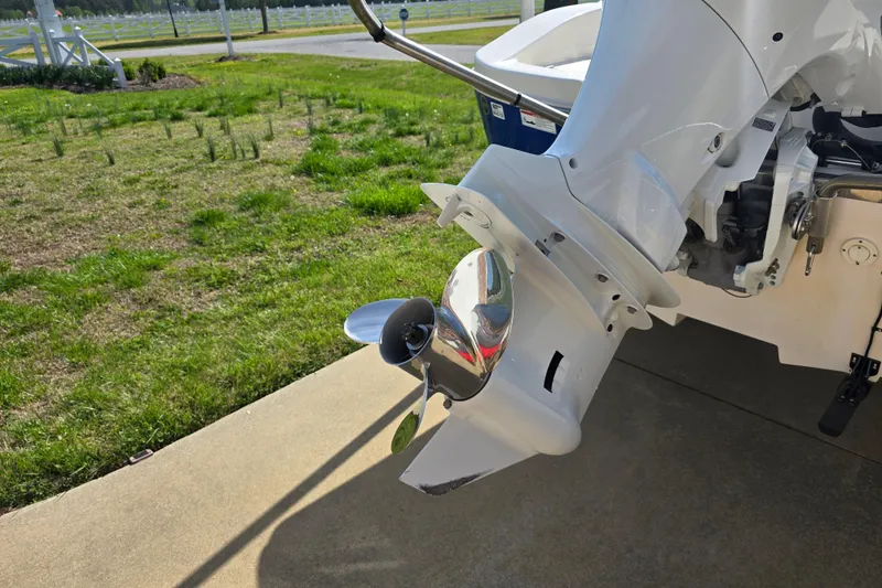Slide: The Image of 2024 Carolina Skiff 24 Ultra Elite boat motor and propeller on a sunny day. - 6