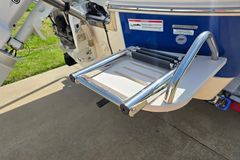 Slide: The Image of 2024 Carolina Skiff 24 Ultra Elite swim platform with ladder, showcasing stainless steel details. - 9