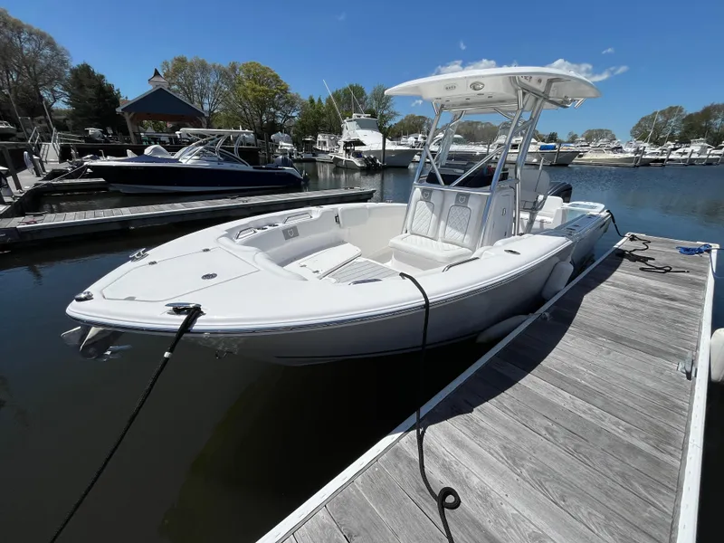 The Image of 2025 Sea Fox 248 Commander boat docked in a marina under clear blue skies. - 0