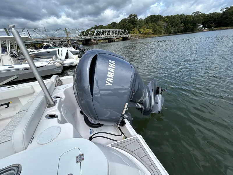 Slide: The Image of 2025 Sea Fox 248 Commander with Yamaha outboard motor on a calm river. - 8