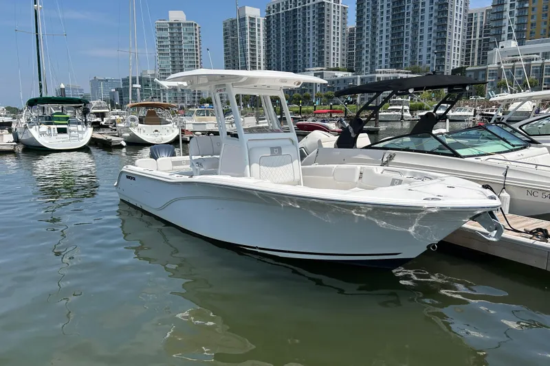The Image of 2025 Sea Fox 248 Commander boat docked in a marina with city skyline. - 1