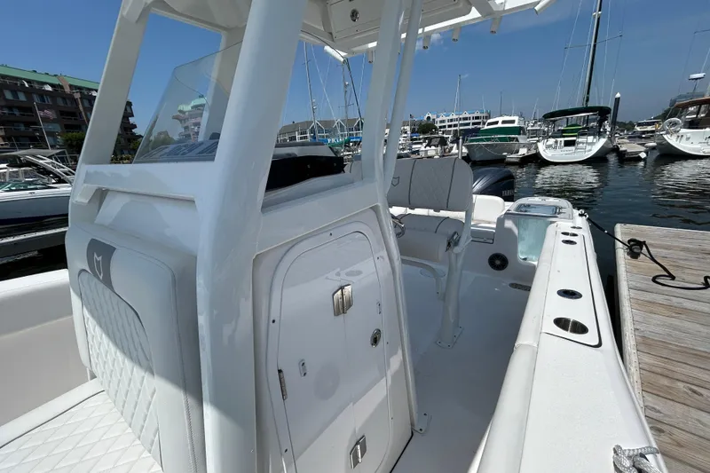 Slide: The Image of 2025 Sea Fox 248 Commander boat docked at marina, showcasing sleek interior design. - 11