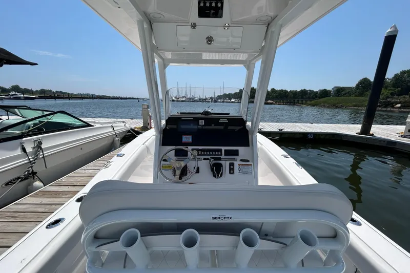 Slide: The Image of 2025 Sea Fox 248 Commander boat at dock, showcasing helm and seating area. - 13