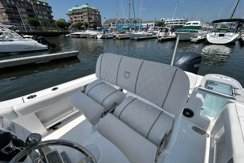Slide: The Image of 2025 Sea Fox 248 Commander boat interior with luxurious seating at a marina. - 16
