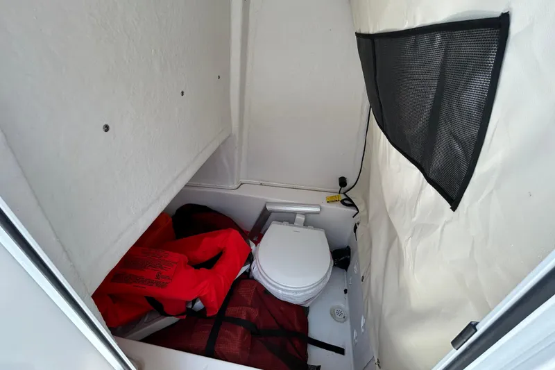 Slide: The Image of Interior of 2025 Sea Fox 248 Commander boat with toilet and life jackets. - 17