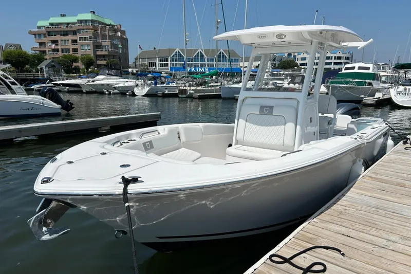 Slide: The Image of 2025 Sea Fox 248 Commander boat docked at a marina with surrounding yachts. - 2