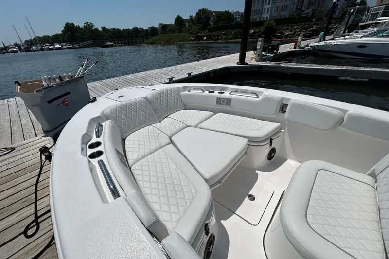 Slide: The Image of 2025 Sea Fox 248 Commander boat with luxurious seating at a marina dock. - 6