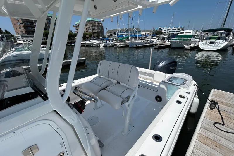 Slide: The Image of 2025 Sea Fox 248 Commander boat docked at marina, featuring dual seats and Yamaha engine. - 7