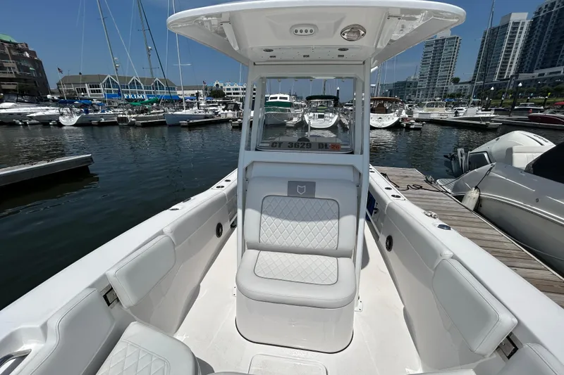 Slide: The Image of 2025 Sea Fox 248 Commander boat docked at a marina, showcasing sleek seating and modern design. - 9