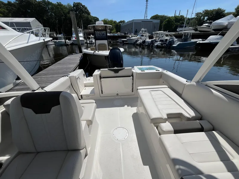 Slide: The Image of 2024 Sailfish 226 DC boat interior at marina, featuring spacious seating and modern design. - 17