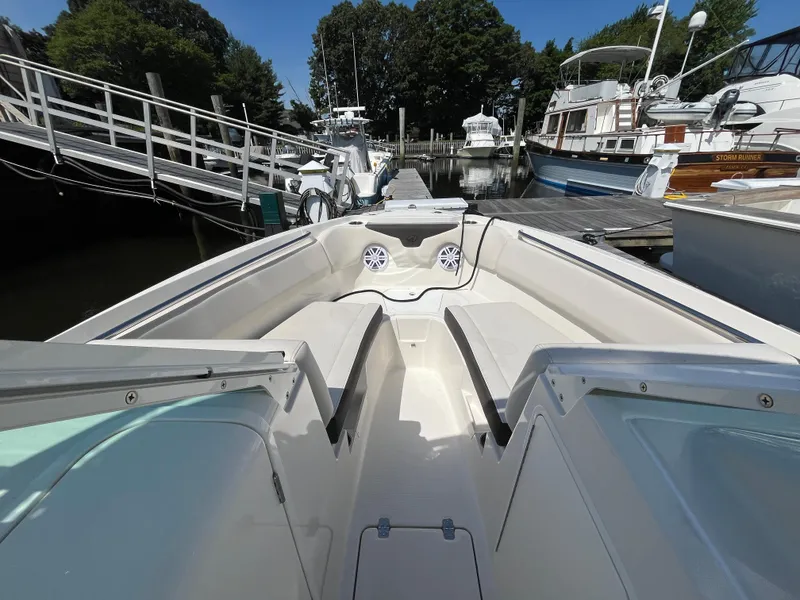 Slide: The Image of 2024 Sailfish 226 DC boat interior at marina, featuring spacious seating and modern design. - 20
