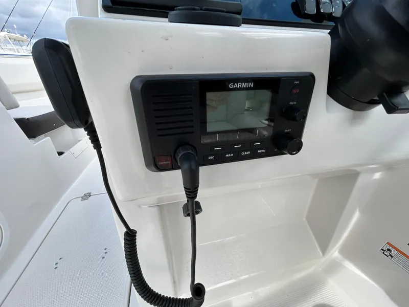 Slide: The Image of Garmin radio on 2024 Sailfish 226 DC boat dashboard. - 24