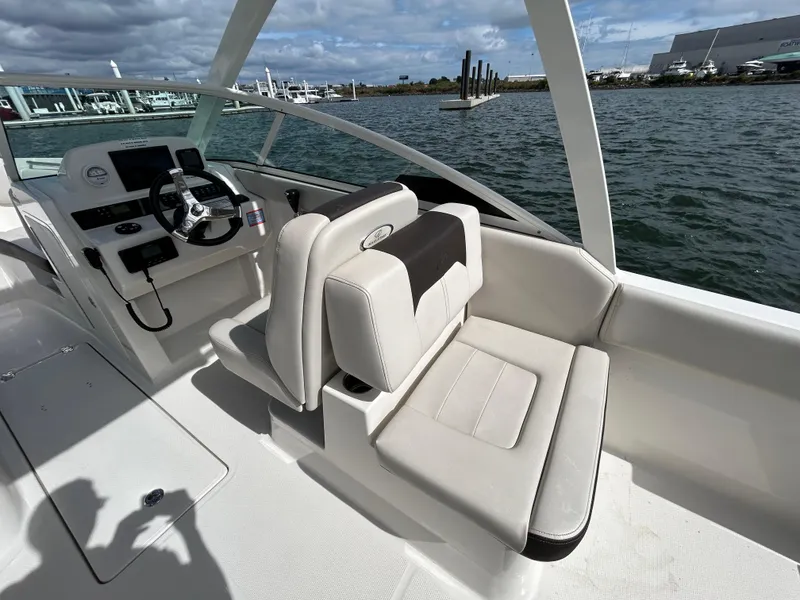 Slide: The Image of 2024 Sailfish 226 DC boat interior with dual console seating on the water. - 9