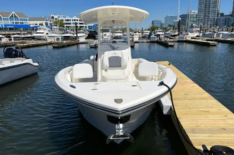Slide: The Image of 2023 Cobia 240 Center Console boat docked at marina, sunny day. - 15