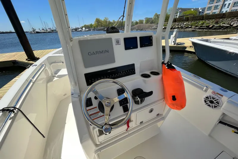 Slide: The Image of 2023 Cobia 240 Center Console boat dashboard with Garmin navigation system. - 19