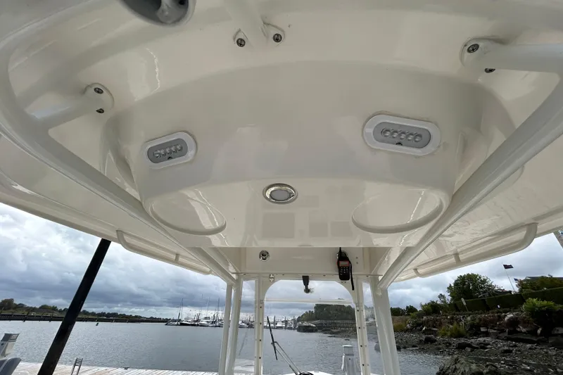 Slide: The Image of 2023 Cobia 240 Center Console boat interior with overhead view at a marina. - 23