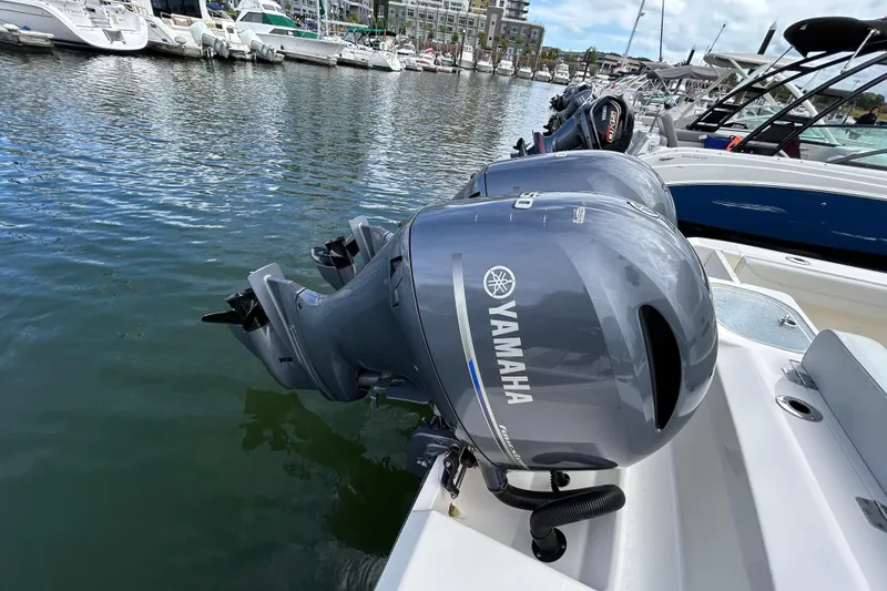 Slide: The Image of 2023 Cobia 240 Center Console with Yamaha outboard engines docked at marina. - 4