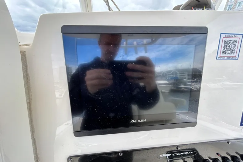 Slide: The Image of Garmin display on 2023 Cobia 240 Center Console boat dashboard with QR code. - 6