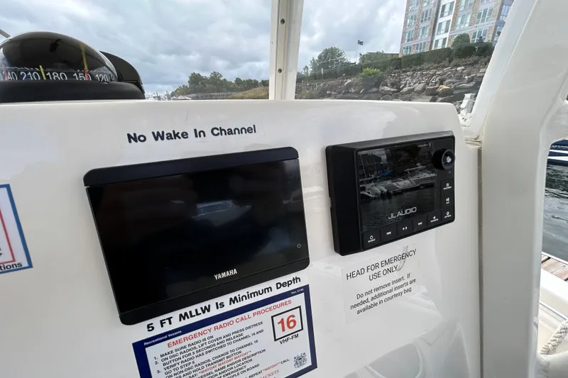 Slide: The Image of 2023 Cobia 240 Center Console dashboard with Yamaha and JL Audio displays. - 7