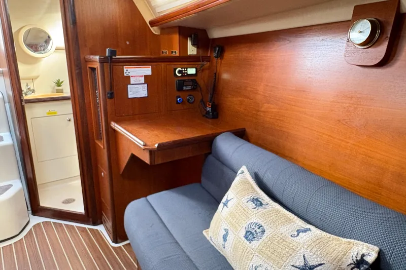 Slide: The Image of Interior of 2006 Hunter 31 sailboat with wooden finish and cozy seating area. - 11
