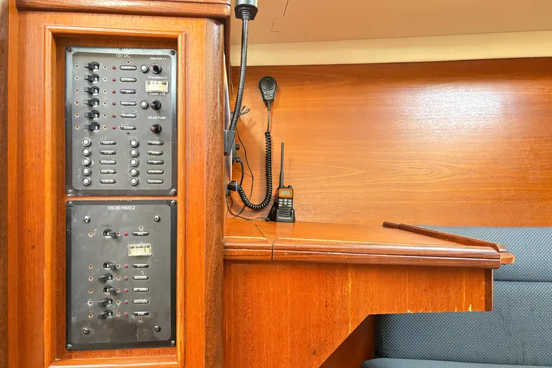 Slide: The Image of Electrical panel and radio equipment inside a 2006 Hunter 31 sailboat cabin. - 12